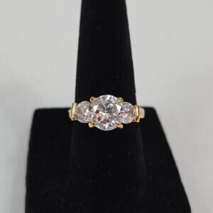 Round Three-Stone Moissanite Trilogy Trellis-Style Engagement Ring Gold Tone
